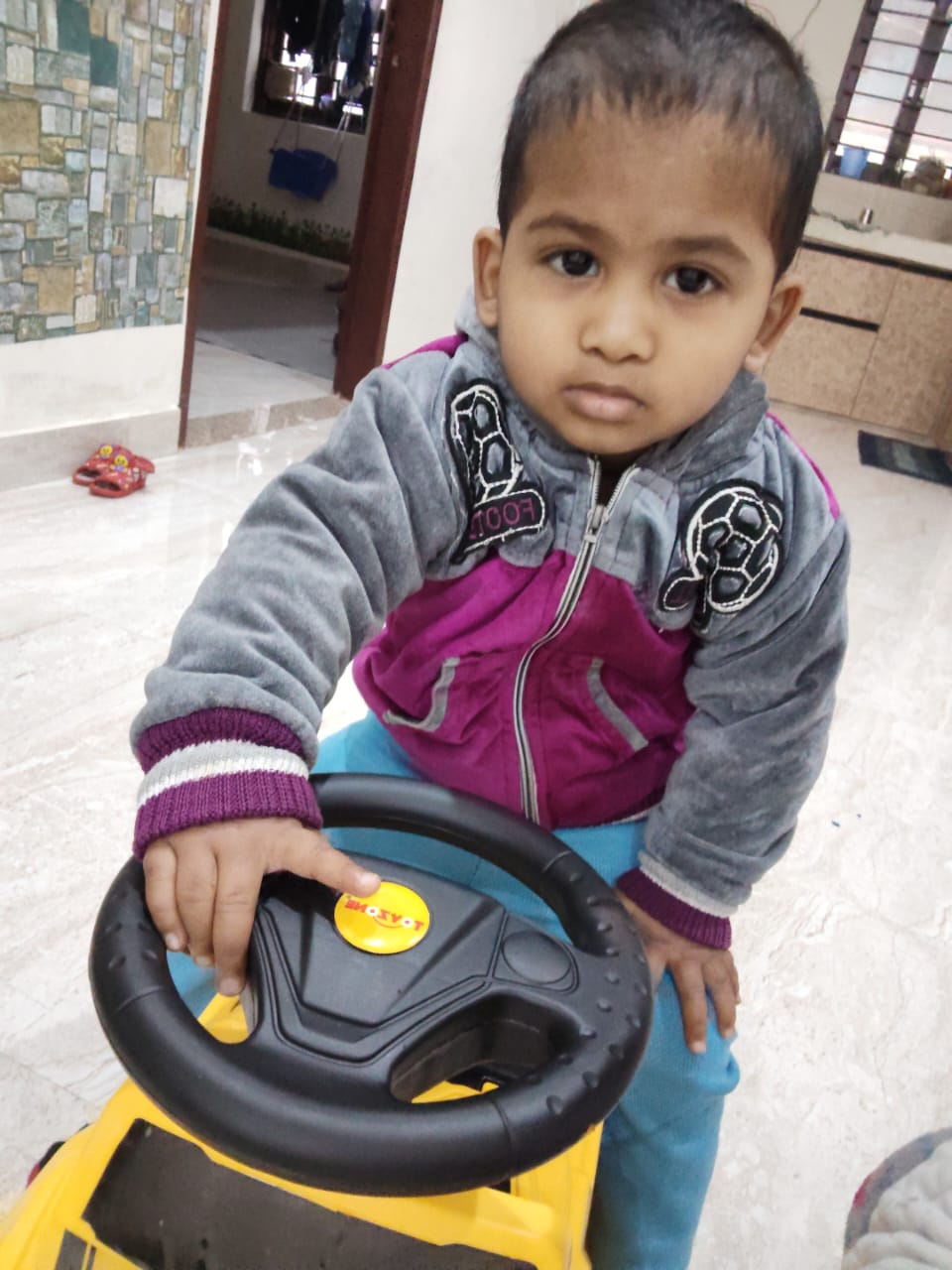 Child riding toy car at PnP Day Care Gurgaon