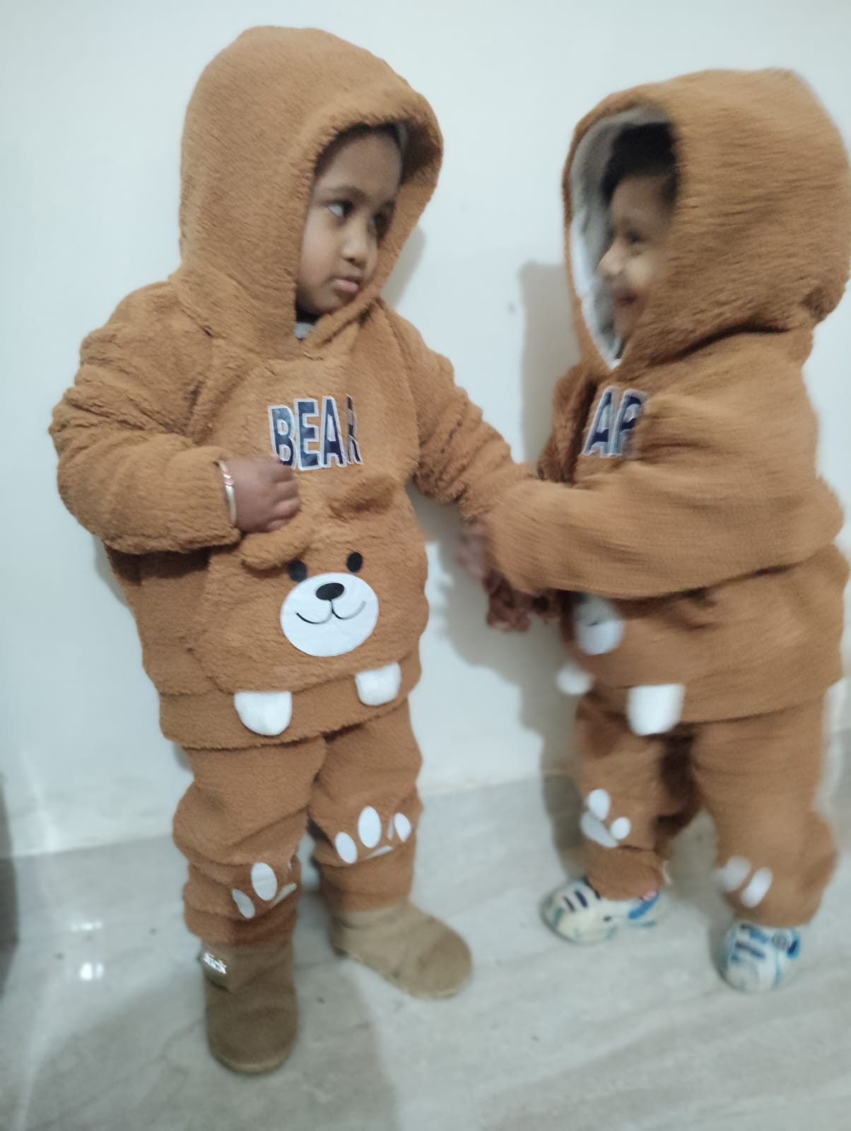 Two toddlers in bear suits